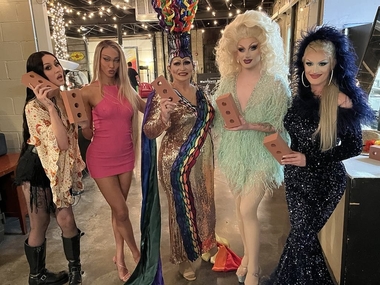 Drag Queen Porche Lynne (c), with other Queens holding their bricks. Photo provided.